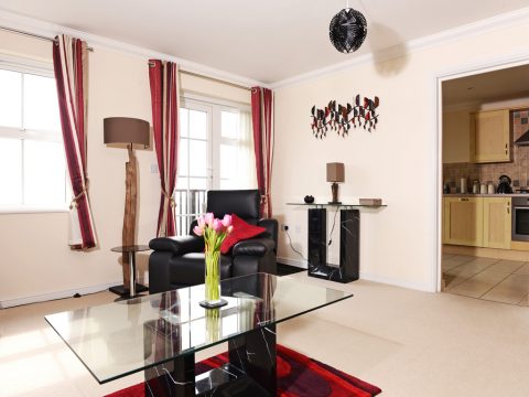 Lounge has patio doors leading to a balcony with sea views